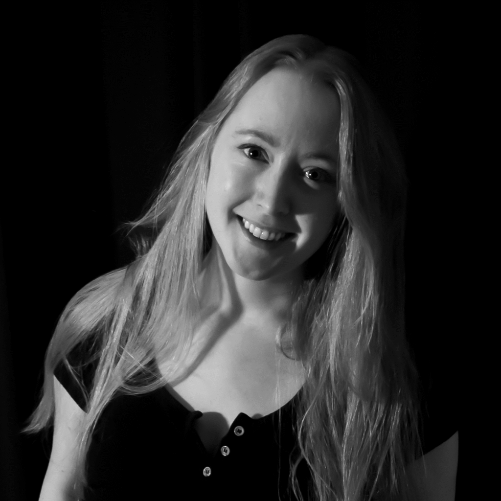 Jodie Cooper, designer, photographed in black-and-white against a black backdrop-square